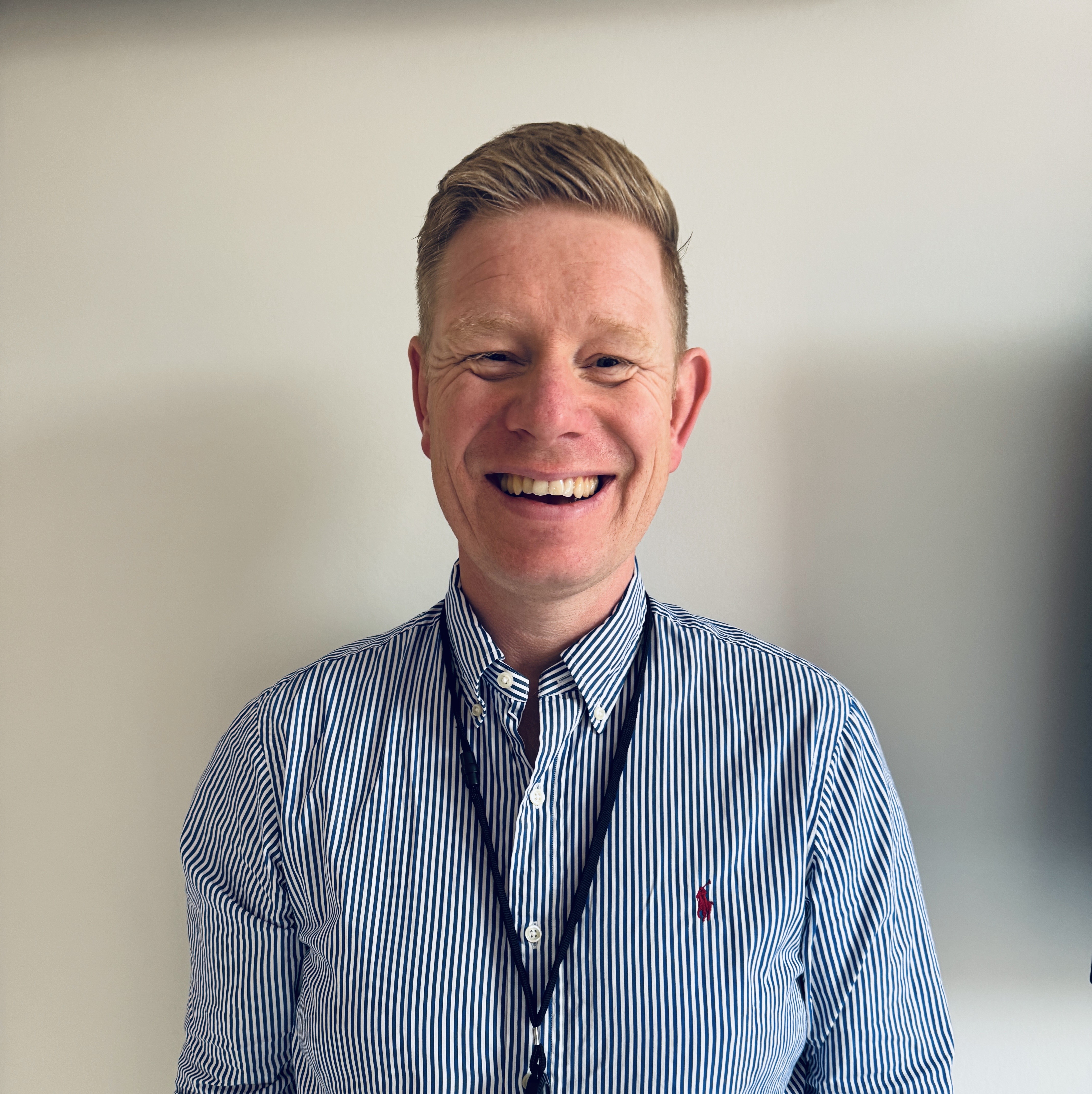 En mann som smiler til kameraet