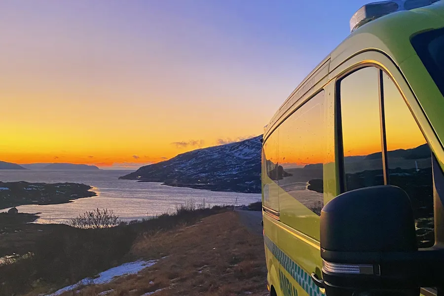Ambulansebil i solnedgang