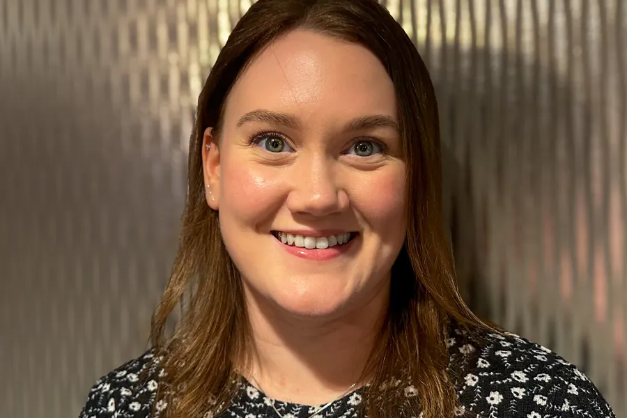 En kvinne som smiler til kameraet