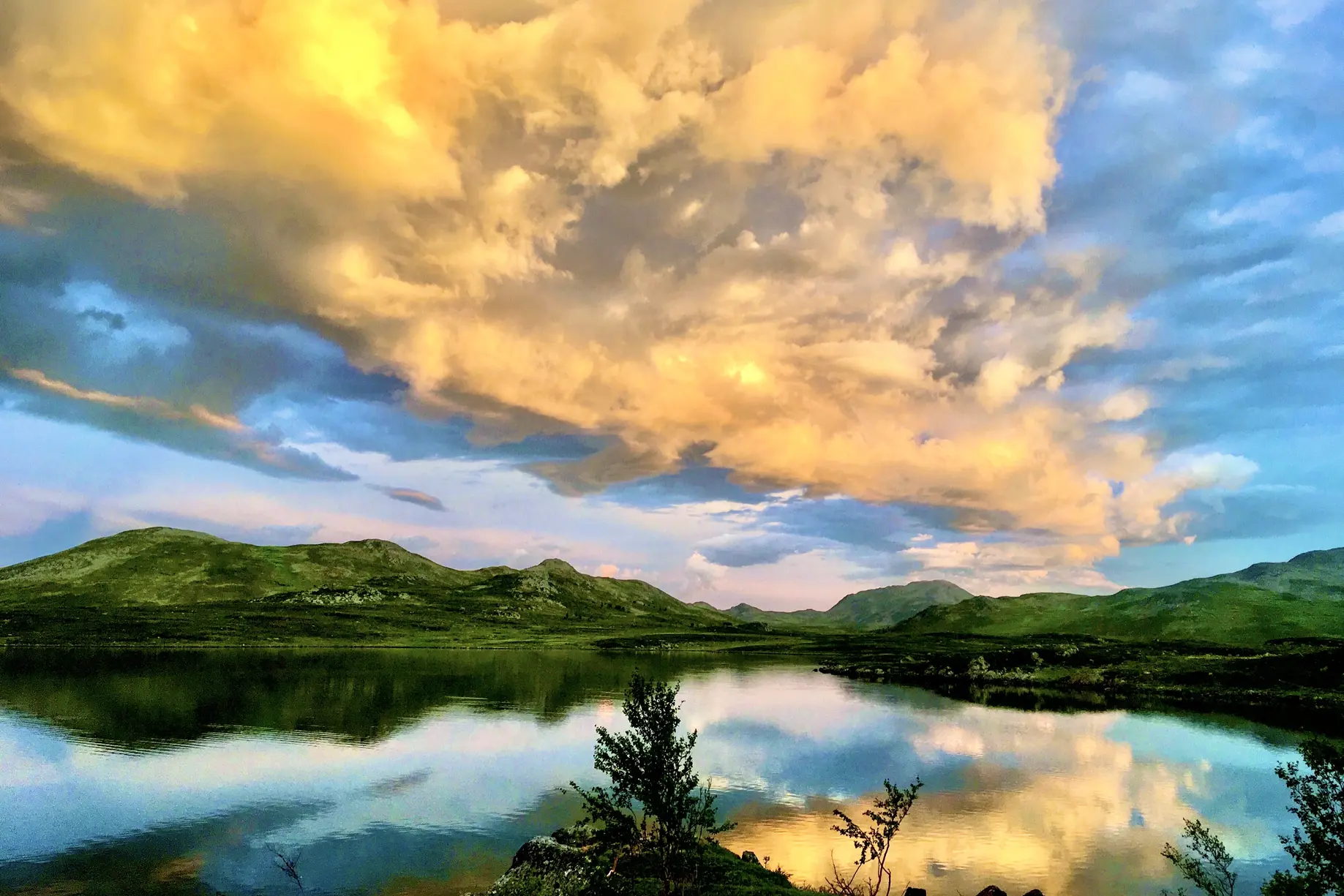 En vannmasse med åser og trær rundt